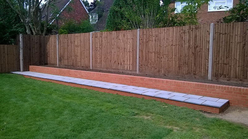 bespoke closeboard fence with raised flowerbed by Paul Timms Fencing